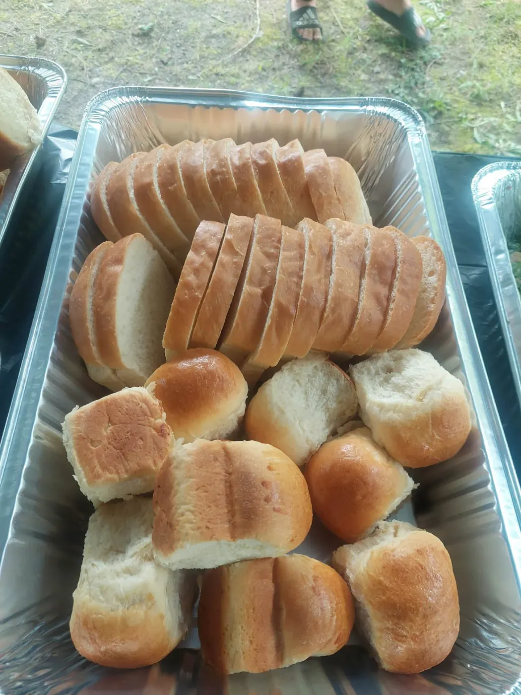 Tray of sliced homemade bread and buns
